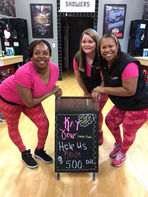 team members standing around chalkboard sign