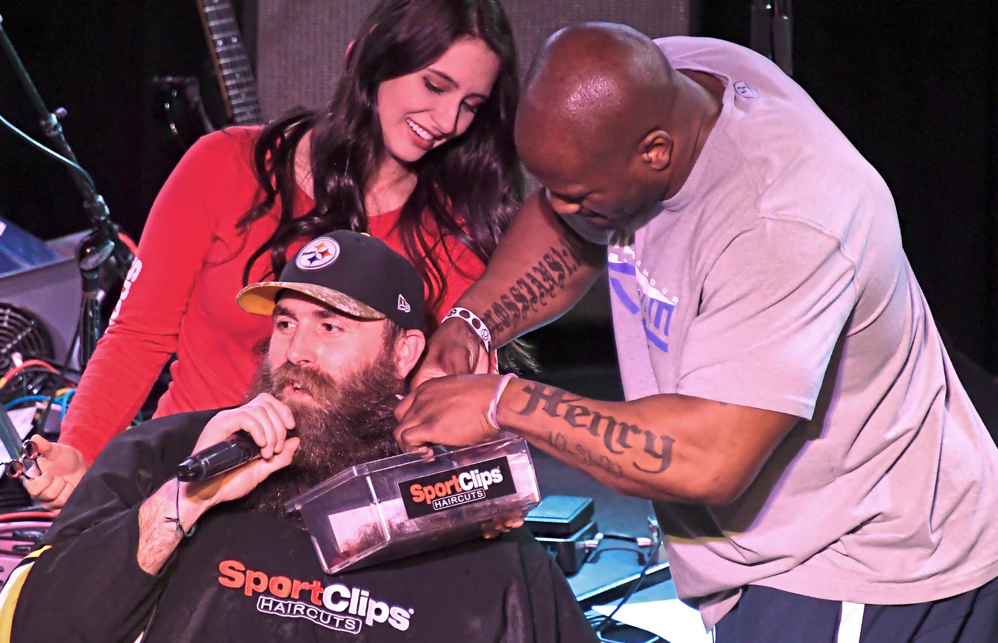 football player getting beard shaved