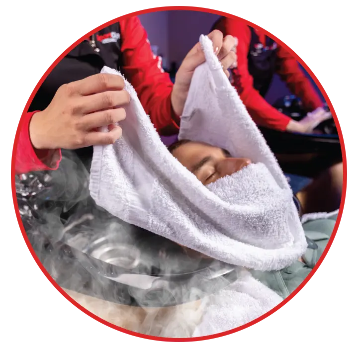 A hot steamed towel on a Sport Clips clients face