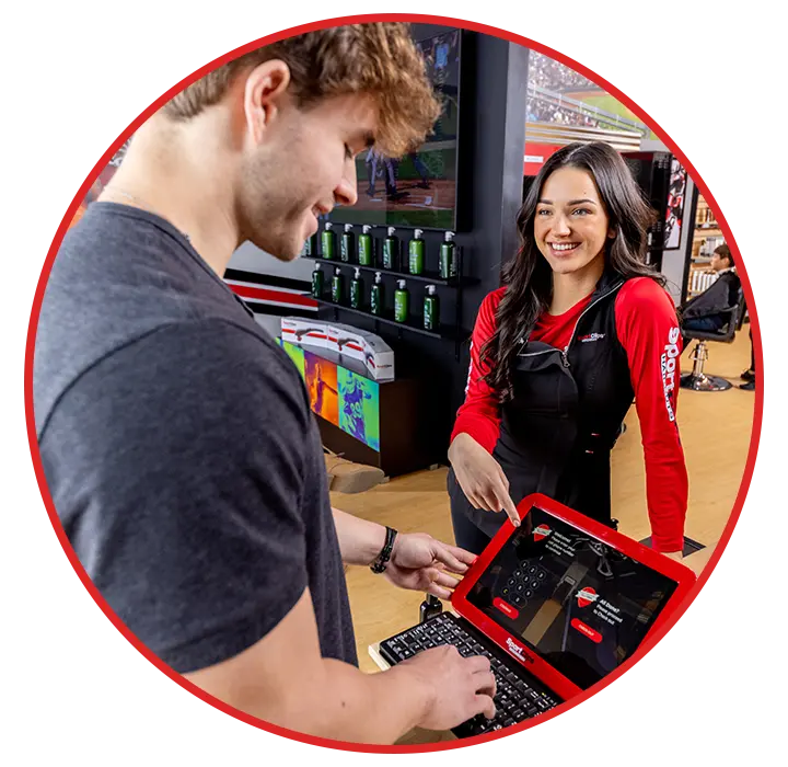 A customer checking in at Sport Clips with help from a stylist