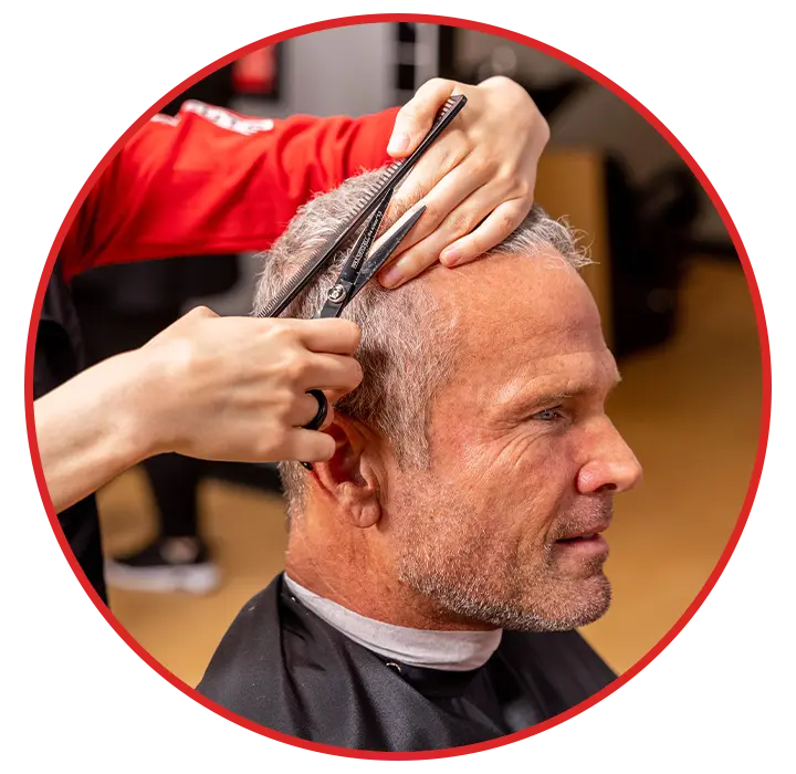 Stylist cutting a mans hair